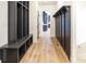 Inviting hallway with custom storage, hardwood floors, and a glimpse of the open floor plan beyond at 11640 Ansley Ct, Zionsville, IN 46077