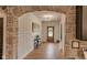 Charming hallway with stone archway, wood floors, and elegant lighting provides a warm welcome at 11640 Ansley Ct, Zionsville, IN 46077