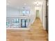 Second story hallway with modern railing and hardwood floors overlooks the floor below at 11640 Ansley Ct, Zionsville, IN 46077