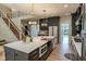 Open-concept kitchen features a large island, modern appliances, and stylish finishes for culinary enthusiasts at 11640 Ansley Ct, Zionsville, IN 46077