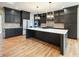 Modern kitchen features dark cabinets, stainless steel appliances, and a spacious island at 11640 Ansley Ct, Zionsville, IN 46077