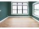 Bright living room with hardwood floors, large windows offering an abundance of natural light, and minimalist design at 11640 Ansley Ct, Zionsville, IN 46077
