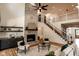 Inviting living room with a stone fireplace, open staircase, and refined décor, perfect for relaxing at 11640 Ansley Ct, Zionsville, IN 46077