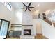 Open-concept living room boasts a stone fireplace, wood floors, and modern staircase at 11640 Ansley Ct, Zionsville, IN 46077
