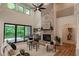 Elegant living room boasts stone fireplace, comfortable seating, and seamless access to the outdoor balcony at 11640 Ansley Ct, Zionsville, IN 46077