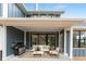 Covered patio with a gas grill, outdoor seating, and glass doors, ideal for outdoor dining and relaxing at 11640 Ansley Ct, Zionsville, IN 46077