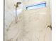 Modern bathroom shower with elegant marble tile and a sleek shower head at 11640 Ansley Ct, Zionsville, IN 46077