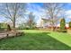 Spacious backyard featuring lush grass and a volleyball net, ideal for outdoor activities and relaxation at 12030 Driftstone Dr, Fishers, IN 46037