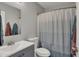 Well-lit bathroom features a vanity with a mirror, and a toilet with a shower with a clean shower curtain at 12030 Driftstone Dr, Fishers, IN 46037