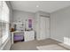 Light filled bedroom with a vanity featuring Hollywood lighting, decoratively painted butterflies, and ample closet space at 12030 Driftstone Dr, Fishers, IN 46037
