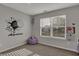 A personalized bedroom featuring a stylish wall decal, a beanbag chair and soft natural light from the window at 12030 Driftstone Dr, Fishers, IN 46037
