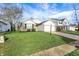 Inviting single-story home with lush green lawn, brick accents, and attached two-car garage, offering curb appeal at 12030 Driftstone Dr, Fishers, IN 46037