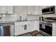 Modern kitchen features stainless steel appliances, white cabinets, and a stylish backsplash at 12030 Driftstone Dr, Fishers, IN 46037