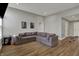 Living area showcases a large sectional sofa, neutral walls, wood-look flooring, and comfortable living space at 12030 Driftstone Dr, Fishers, IN 46037
