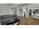 Open-concept living room with a view of the kitchen, dining area, and comfortable sectional sofa at 12030 Driftstone Dr, Fishers, IN 46037