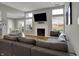 Cozy living room with a fireplace, large comfortable sectional sofa, and bright natural light at 12030 Driftstone Dr, Fishers, IN 46037