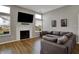 Spacious living room featuring a fireplace, large sectional sofa, and bright natural light through the windows at 12030 Driftstone Dr, Fishers, IN 46037