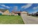 Charming single-story brick home with well-manicured lawn and attached two-car garage at 12334 Buckley Blvd, Indianapolis, IN 46229