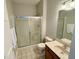 Neutral bathroom features shower with sliding glass doors, single sink vanity and mirror at 1238 Passage Way, Plainfield, IN 46168
