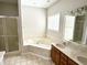 Primary bathroom featuring a dual sink vanity, separate shower, and soaking tub at 1238 Passage Way, Plainfield, IN 46168