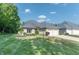 Charming brick home featuring a two-car garage, lush lawn, and beautifully landscaped front yard at 1238 Passage Way, Plainfield, IN 46168