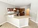Cozy kitchen with wood cabinets, neutral countertops and backsplash, and modern lighting at 1238 Passage Way, Plainfield, IN 46168