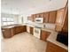 Bright kitchen with wood cabinets, neutral countertops and backsplash, and white appliances at 1238 Passage Way, Plainfield, IN 46168