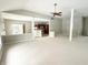 Open-concept living area with a view to the kitchen and large windows providing ample light at 1238 Passage Way, Plainfield, IN 46168