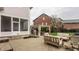 Spacious backyard featuring outdoor lounge seating, a pergola, and a well-manicured lawn, ideal for relaxation and gatherings at 12813 Chapel Square St, Carmel, IN 46032