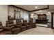 Basement theater area boasts leather recliners, wet bar, custom trim, and striking decor with ample room at 12813 Chapel Square St, Carmel, IN 46032