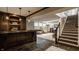 Finished basement with a wet bar, decorative stairs and luxurious seating area, perfect for entertaining at 12813 Chapel Square St, Carmel, IN 46032