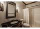 Bathroom featuring a dark wood vanity, decorative mirror, and a shower with a white curtain at 12813 Chapel Square St, Carmel, IN 46032