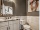 Elegant powder room featuring marble countertops, stylish mirror, and decorative artwork at 12813 Chapel Square St, Carmel, IN 46032