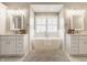 Luxurious bathroom with a soaking tub, dual vanities, and modern fixtures at 12813 Chapel Square St, Carmel, IN 46032