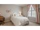 Charming bedroom with a cozy bed, decorative wall accents, and a window with curtains for a peaceful retreat at 12813 Chapel Square St, Carmel, IN 46032