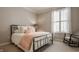 Cozy bedroom with a metal bed frame, a striped throw, and a rocking chair for relaxation at 12813 Chapel Square St, Carmel, IN 46032