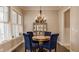 Formal dining room featuring hardwood floors, chandelier and natural light at 12813 Chapel Square St, Carmel, IN 46032