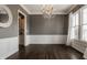 Elegant dining room with a chandelier, large windows, and detailed wainscoting at 12813 Chapel Square St, Carmel, IN 46032
