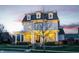 Charming two-story home boasts a welcoming porch and manicured landscaping, creating a picturesque curb appeal at 12813 Chapel Square St, Carmel, IN 46032