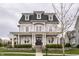 Charming two-story home with a classic design, featuring a welcoming front porch and landscaped garden at 12813 Chapel Square St, Carmel, IN 46032