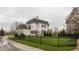 Rear exterior view of home with a spacious yard, patio and black ornamental fence at 12813 Chapel Square St, Carmel, IN 46032