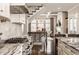 Open floor plan showcasing kitchen with island, stainless appliances, hardwood floors and open staircase at 12813 Chapel Square St, Carmel, IN 46032