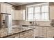 Bright eat-in kitchen with stainless appliances, island with granite countertops, and modern lighting at 12813 Chapel Square St, Carmel, IN 46032