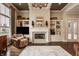Spacious living room boasts a fireplace, built-in shelving, and plenty of natural light at 12813 Chapel Square St, Carmel, IN 46032