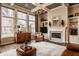 Comfortable living room with coffered ceilings, fireplace, and leather armchair at 12813 Chapel Square St, Carmel, IN 46032