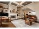 Spacious living room with fireplace, hardwood floors, and view into gourmet kitchen at 12813 Chapel Square St, Carmel, IN 46032