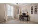 Bright office space featuring neutral walls, large window, built-in bookcases, and a sleek desk with stylish decor at 12813 Chapel Square St, Carmel, IN 46032