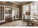Sophisticated home office with glass desk, hardwood floors, and natural light at 12813 Chapel Square St, Carmel, IN 46032