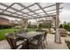 Charming pergola shades an outdoor dining set and lounge seating in a green backyard at 12813 Chapel Square St, Carmel, IN 46032