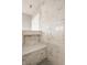 Close-up of a luxurious marble shower with built-in bench and niche at 12813 Chapel Square St, Carmel, IN 46032